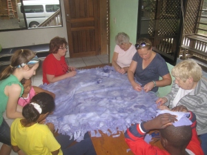 Children help out with making blankets.