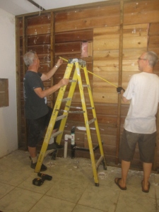 Dave and Rick prepare to install a wall in the girl's bathroom.
