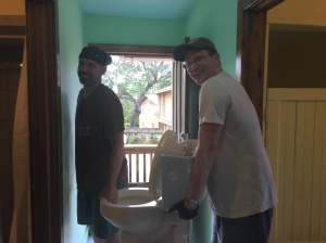 Wade and John removing an old toilet